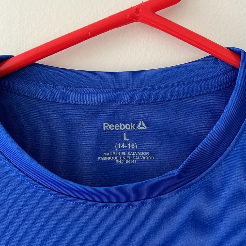 Reebok youth boys size 14-16 blue Savage on the Field shirt.